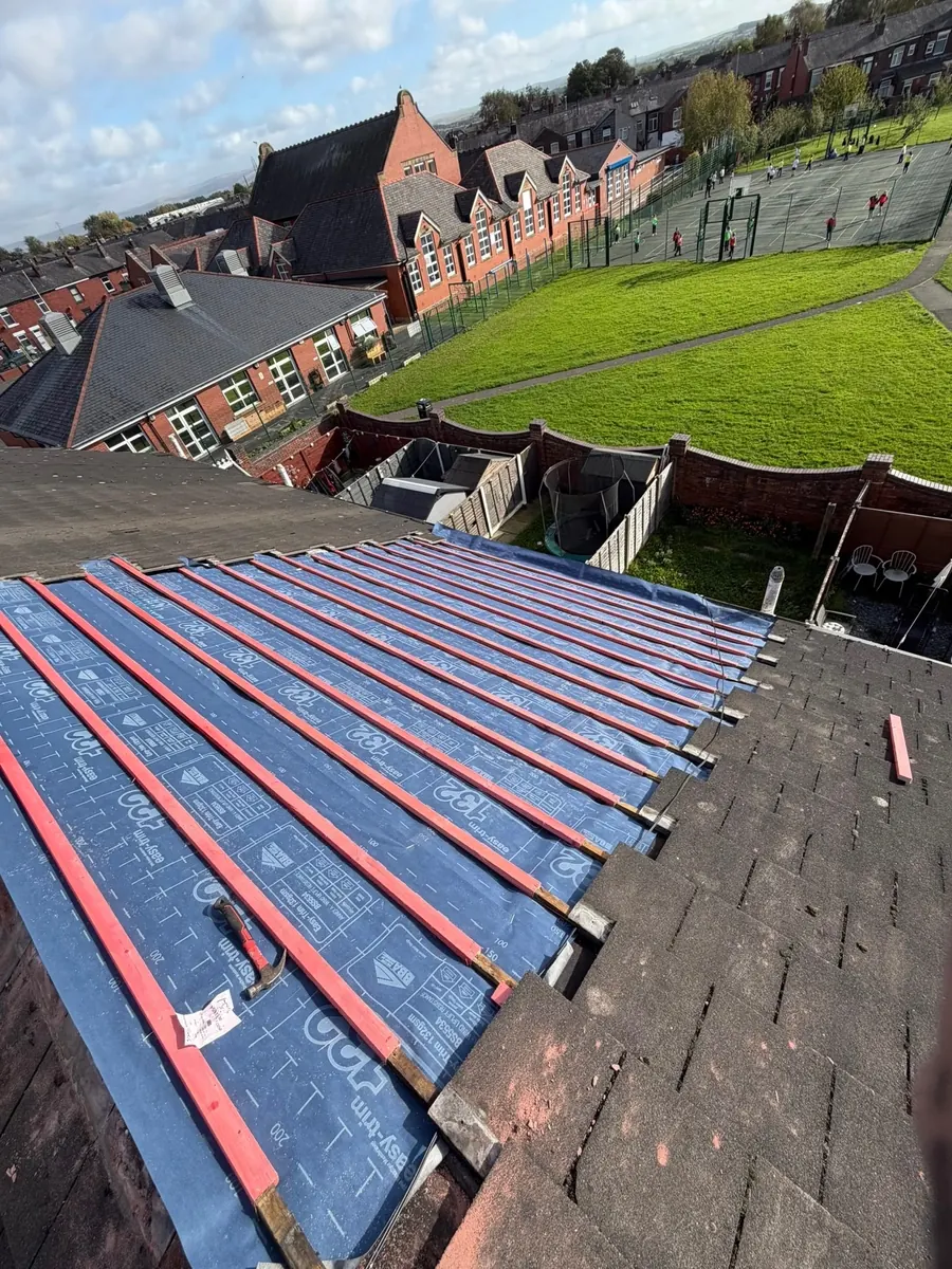 New treated battens over breathable membrane next to the old tiles, Dawn Roofs Ltd