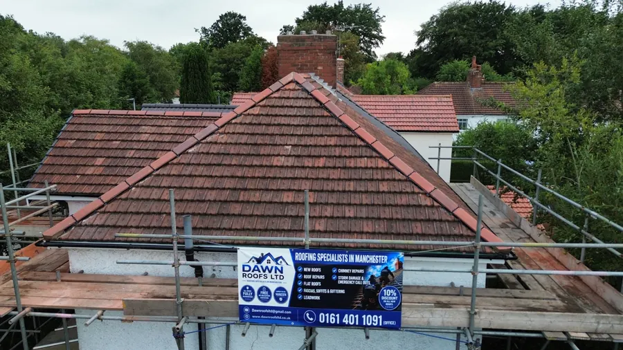 Drone view of a bungalow roof with the Dawn Roofs banner on the scaffold, Dawn Roofs Ltd