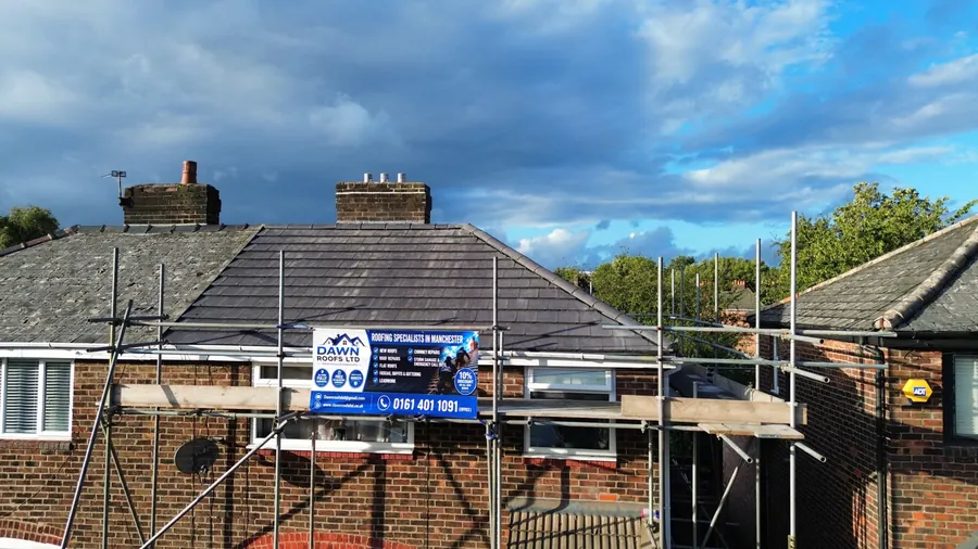 Drone view of a grey tile bungalow roof from the front, with the Dawn Roofs banner on the scaffold, Dawn Roofs Ltd