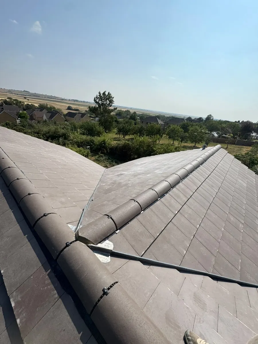 Grey tile hip meeting the main ridge, Dawn Roofs Ltd