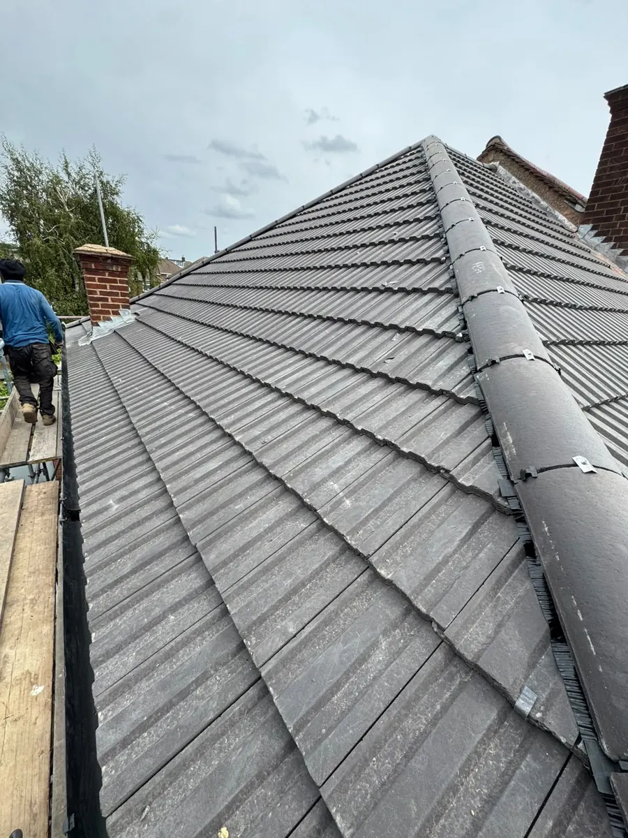 Grey tile roof with a long new ridge, Dawn Roofs Ltd