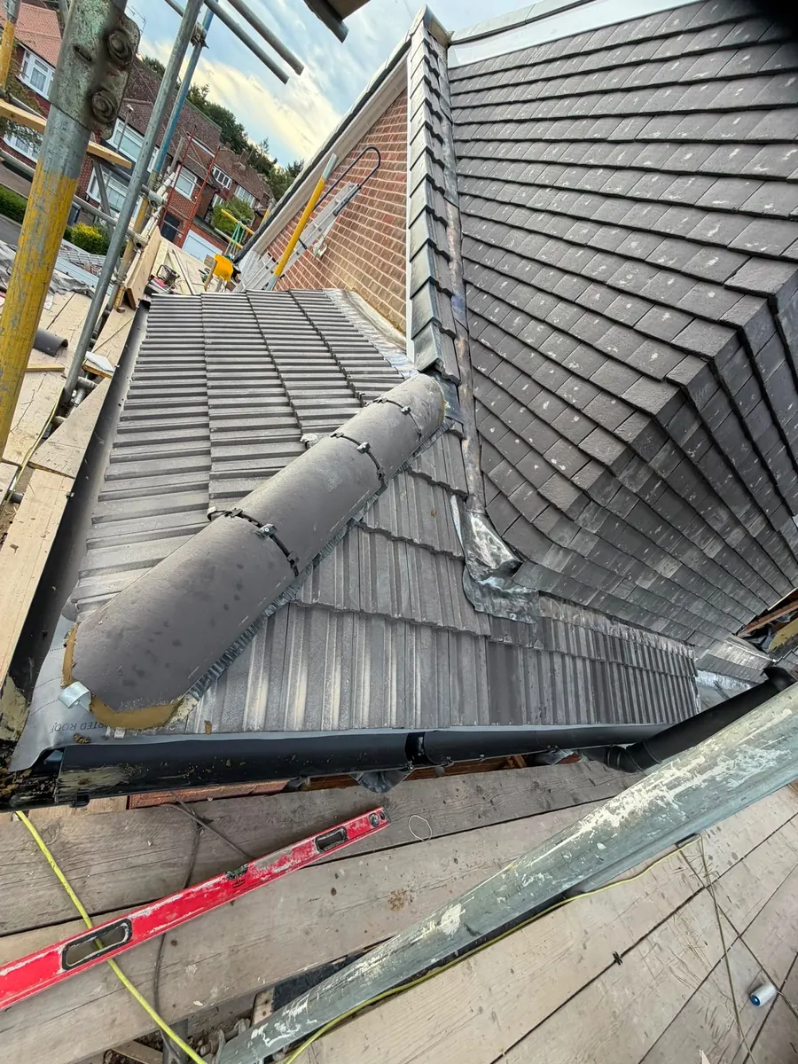 Grey tile ridge finished above the scaffold, Dawn Roofs Ltd