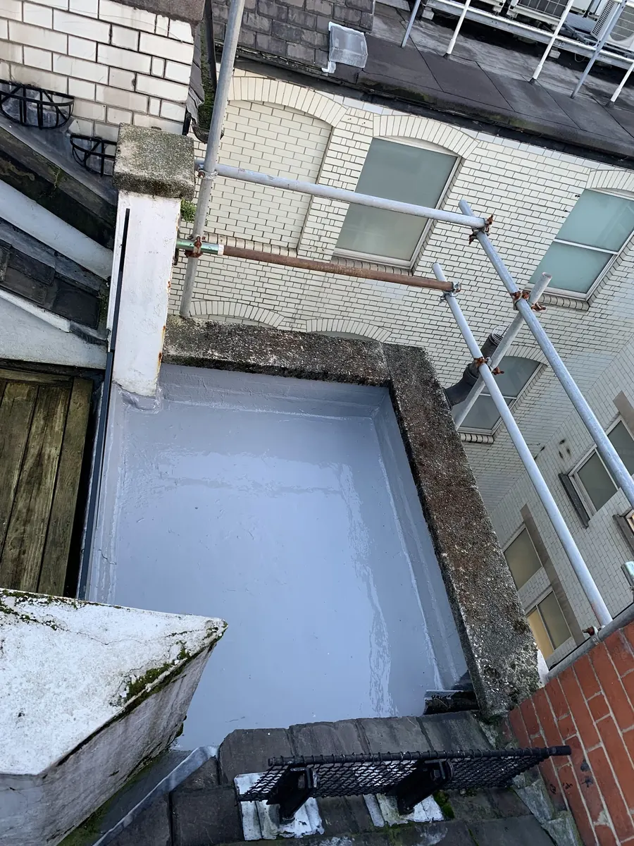 Light grey GRP flat roof finished between walls, Dawn Roofs Ltd