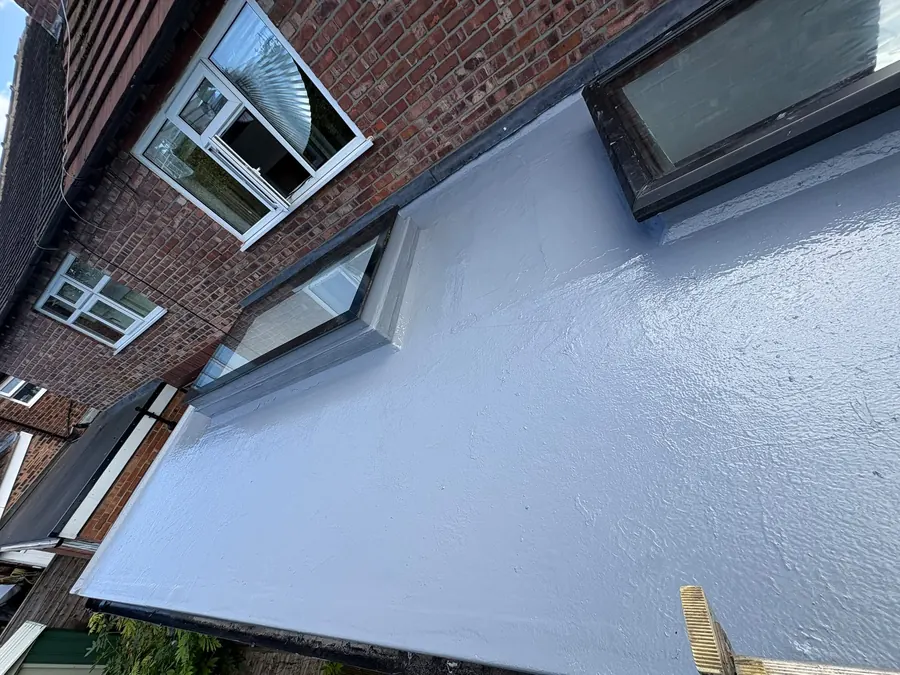 Grey GRP flat roof with a roof window, Dawn Roofs Ltd