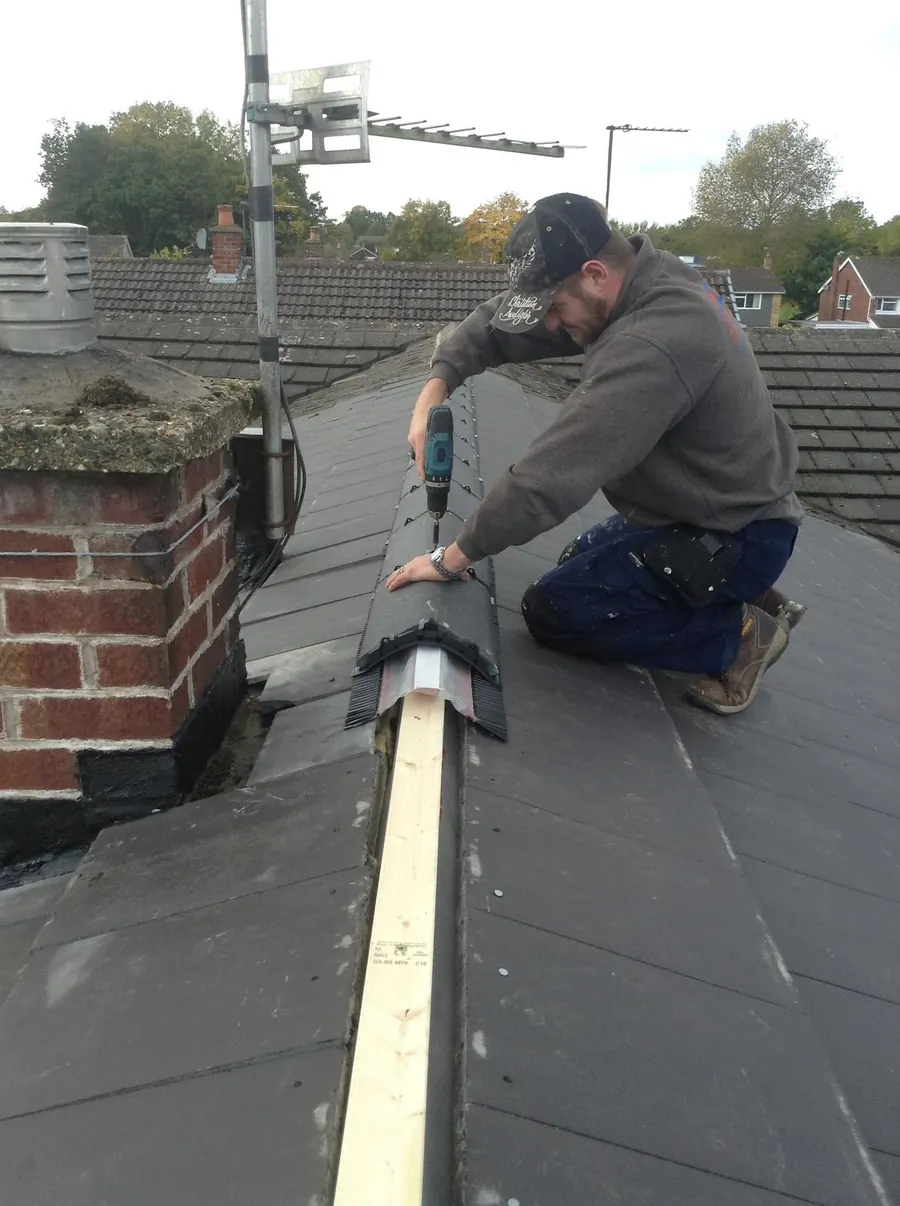 Roofer fixing a dry ridge on a new roof, Dawn Roofs Ltd