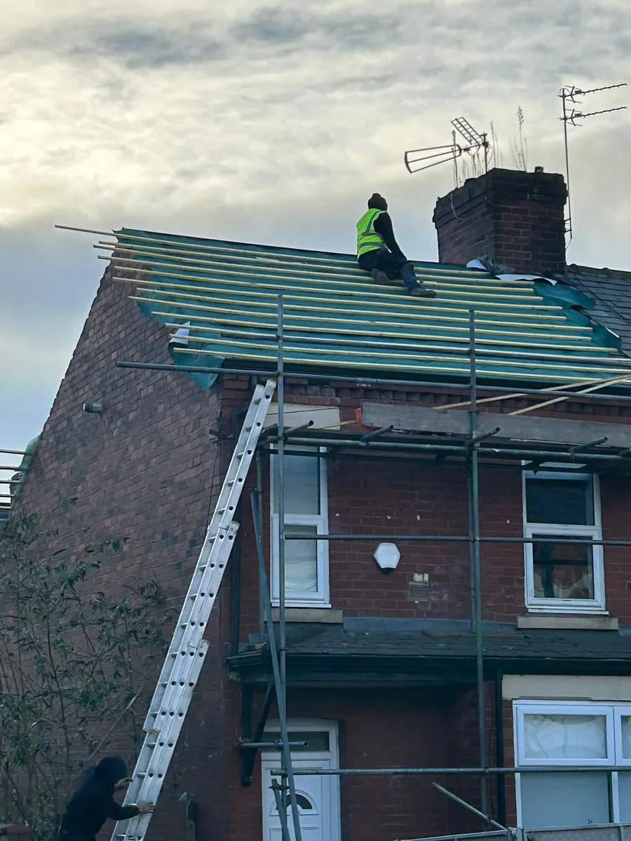 Roofer on new membrane on a tall terraced house, Dawn Roofs Ltd