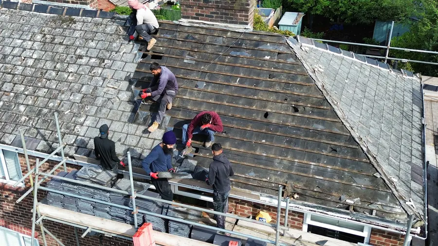 The team at work on a roof, photographed by the customer, Dawn Roofs Ltd