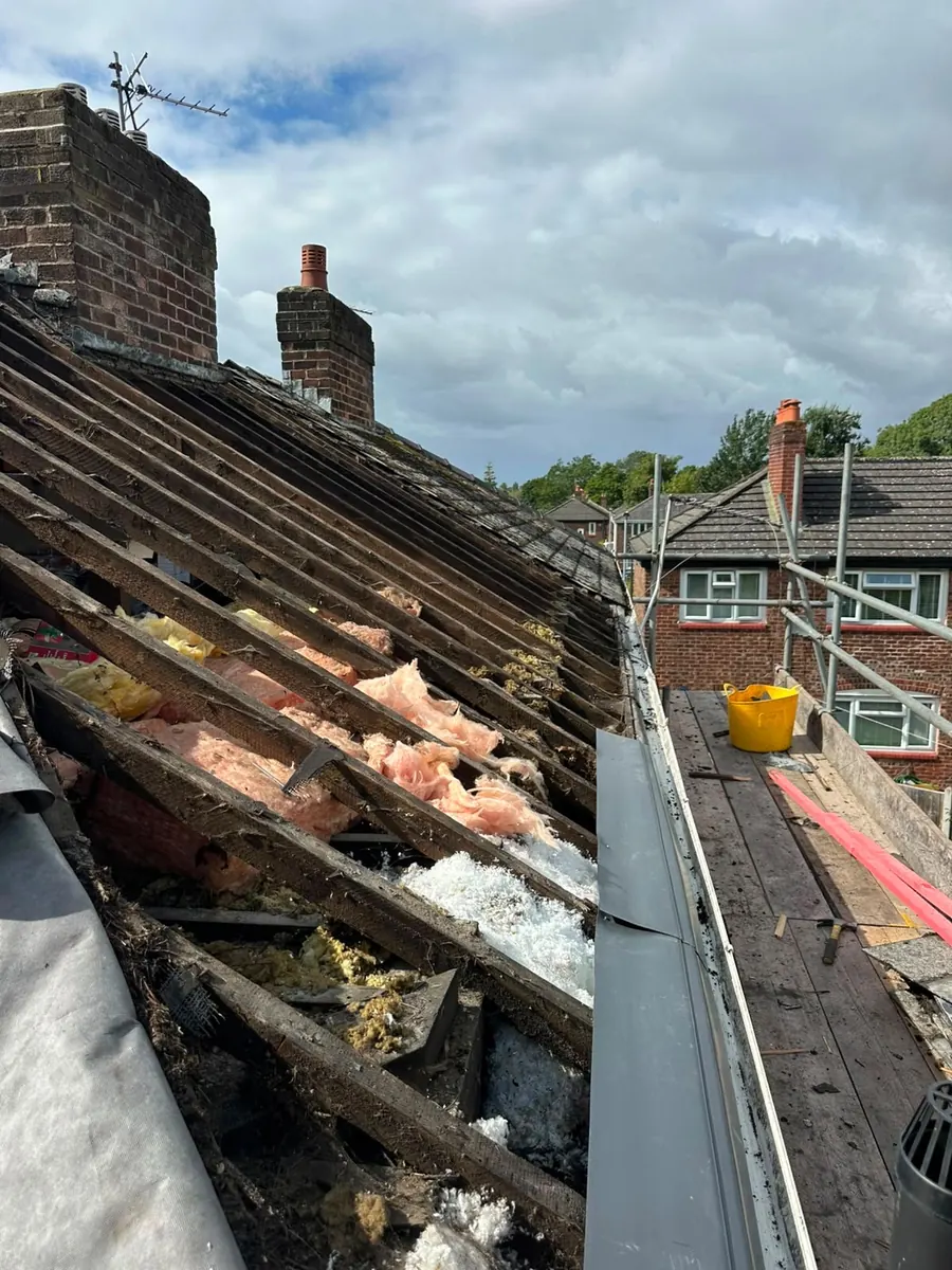 Tiles stripped back at the ridge during repairs, Dawn Roofs Ltd